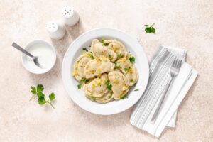 Homemade pierogi, dumplings, varenyky or vareniki with cabbage, top view